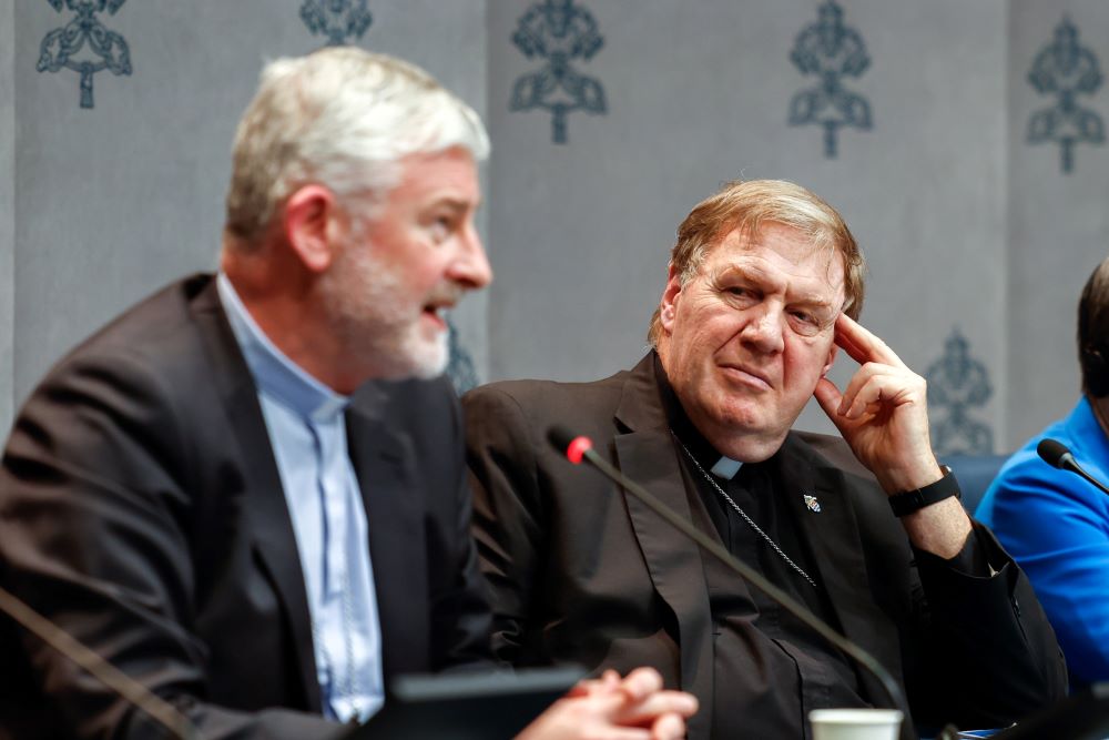 Cardinal Joseph W. Tobin of Newark, N.J., looks on at the Vatican Oct. 11 as Bishop Shane Anthony Mackinlay of Sandhurst, Australia, speaks at a press briefing on the synod.