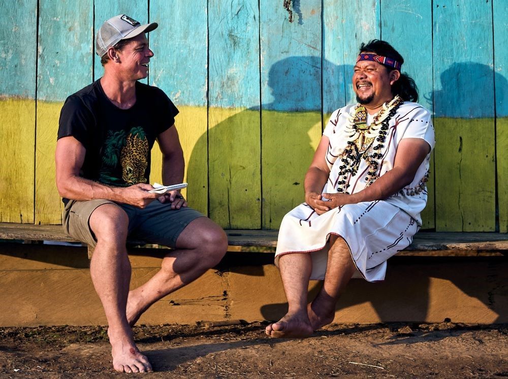 Amazon Frontlines co-founder Mitch Anderson, left,  speaks with Siekopai leader and partner Justino Piaguaje in Siekopai ancestral territory on the border between Peru and Ecuador in the Amazon basin. Amazon Frontlines won the $2.5 million Hilton Humanitarian Prize from the the Conrad N. Hilton Foundation. (Amazon Frontlines/Christopher Fragapane)