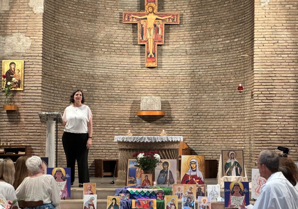 Ellie Hidalgo speaks to members of Discerning Deacons during an Oct. 3 prayer service at the San Lorenzo chapel of Centro Internazionale Giovanile in Rome. Displayed are representations of St. Phoebe, thought to be an early deacon in the church mentioned by St. Paul the Apostle. (NCR photo/ Rhina Guidos) 