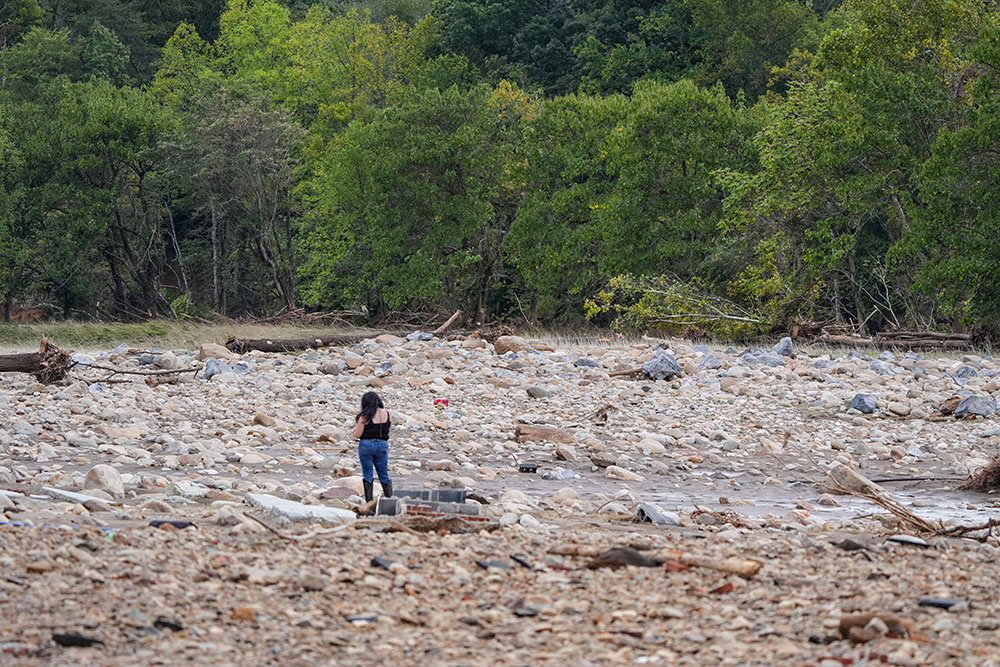 A woman stands where the Jet Broadcasting radio station once stood in Erwin, Tennessee, Sept. 29. The staton's entire building was swept away in the flood waters caused by Hurricane Helene. (OSV News/USA TODAY NETWORK via Reuters/The Knoxville News-Sentinel/Saul Young)