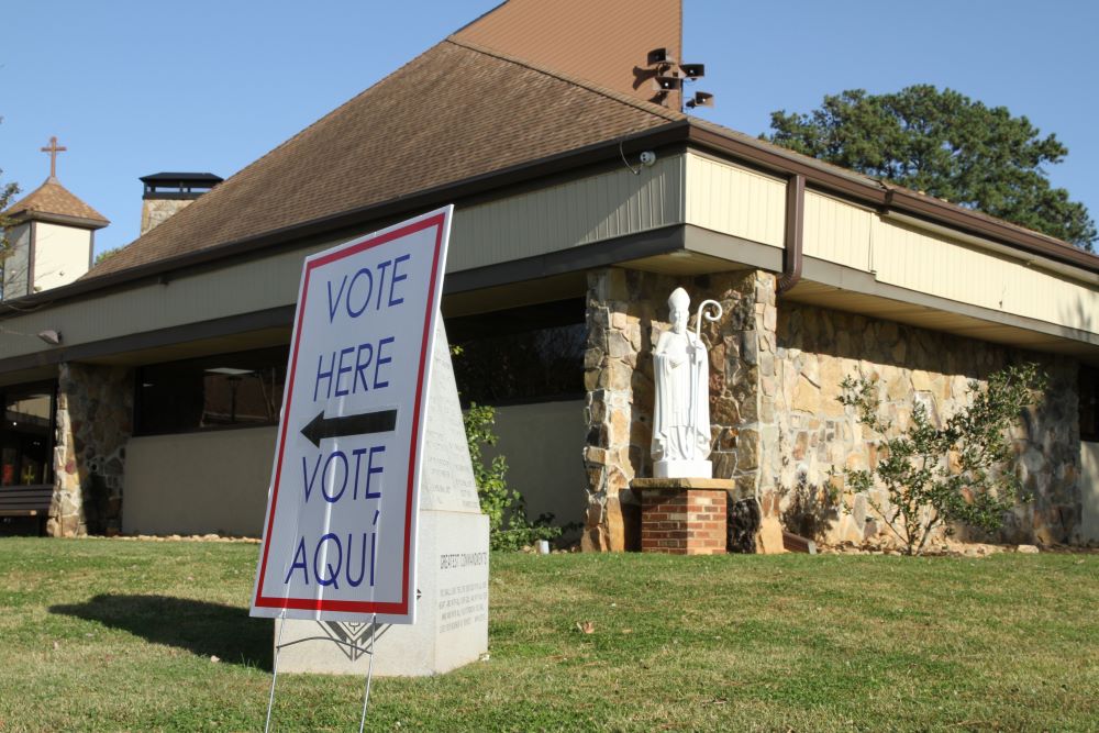 A bilingual voting sign is seen at St. Patrick Church polling station in Norcross, Ga., on Election Day 2020. 