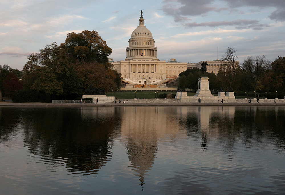 The sun sets on the U.S. Capitol building as seen from the Capitol Reflecting Pool in Washington on Nov. 6, the day after Republican President-elect Donald Trump was elected the 47th president of the United States. (OSV News/Reuters/Leah Millis)