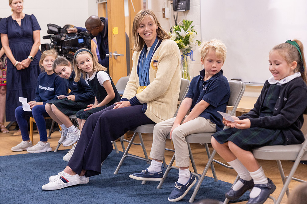 Olympic swimming champion Katie Ledecky visits her alma mater, Stone Ridge School of the Sacred Heart in Bethesda, Md., on Oct. 22 and listens as second grader Anna Reilly at right asks her a question. The other students from left to right are fourth grader Annie Siciliano, third grader Lilly Bracewell, first grader Amelia Farrell and kindergartener Bowen Wiegmann. (OSV News/Catholic Standard/Mihoko Owada)