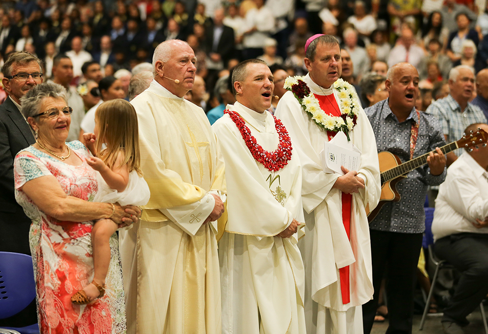 Family members and others are seen during the Maori welcome just before the episcopal ordination Mass at the Vodafone Events Centre in south Auckland, New Zealand, March 7, 2020. Pictured are Maureen Gielen, of Deacon Henk Gielen, second from left, then-Bishop-designate Michael Gielen and Bishop Stephen Lowe, then-bishop of Hamilton, New Zealand. (CNS/NZ Catholic/Joey Bonnevie)