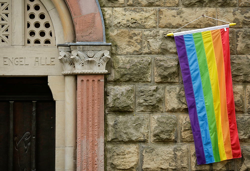 A rainbow flag is seen on the wall of a Catholic church in Cologne, Germany, May 10, 2021, as the building is open for same-sex couples to receive a blessing. Pope Francis formally approved letting Catholic priests bless people in same-sex unions, the Vatican announced Dec. 18, 2023. (OSV News/Reuters/Thilo Schmuelgen)