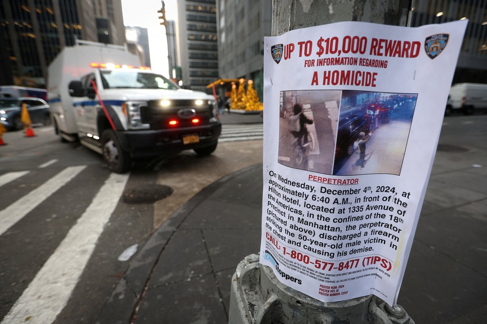 Poster on utility pole, emergency vehicle in background.