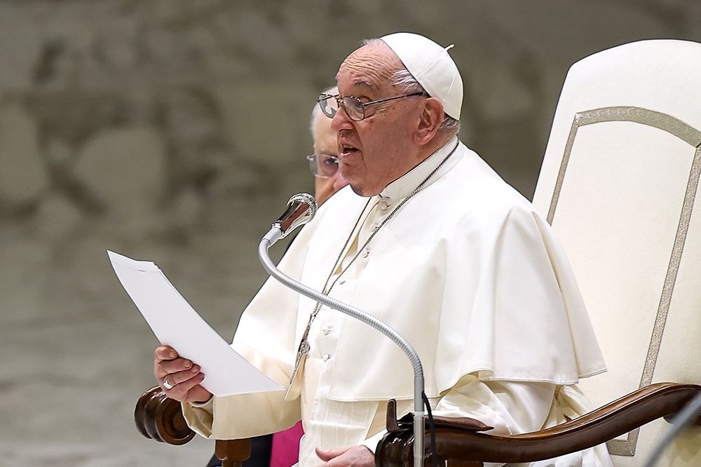 Pope Francis talks to visitors during his weekly general audience in the Paul VI Audience Hall at the Vatican Dec. 11, 2024. (CNS/Lola Gomez)