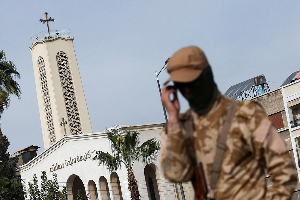 A rebel fighter guards the street in front of Lady of Damascus Church in Syria Dec. 11, 2024, after rebels seized the capital and ousted Syria's Bashar al-Assad. (OSV News/Reuters/Amr Abdallah Dalsh)