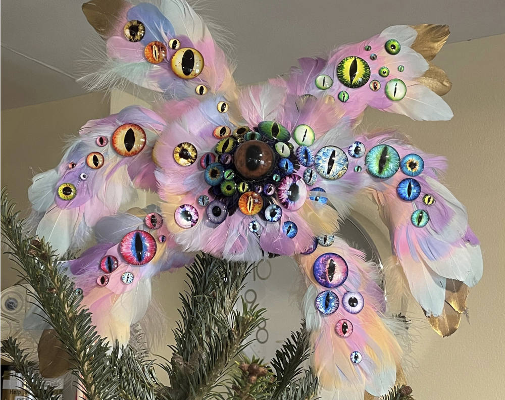 This Dec. 12, 2021, photo shows the biblically accurate angel Christmas tree topper created by the Rev. Kira Austin-Young and her puppet-maker husband, Michael Schupbach, atop the tree in their former home in Nashville, Tenn. (Kira Austin-Young via AP)