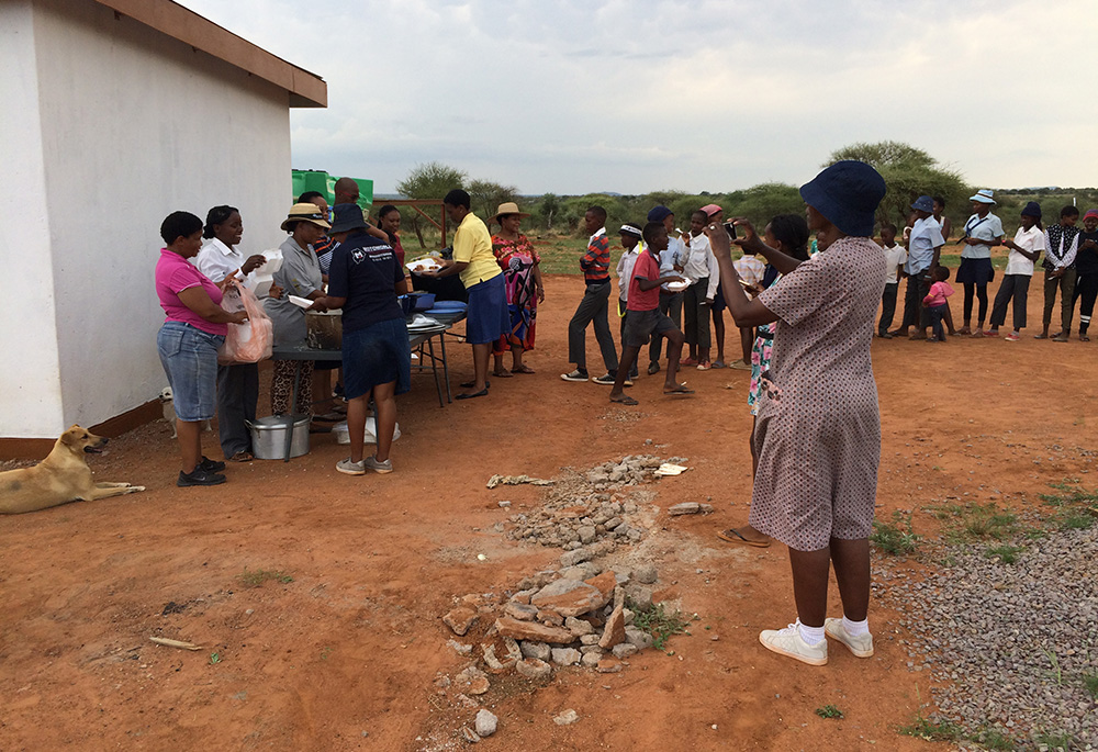 Guests enjoy a festive Christmas lunch featuring typical "keresemose" food at the annual "Keresemose kwa Masimong" ("Christmas in the Fields") celebration, hosted by the sisters and volunteers for the rural community. (Courtesy of Pulane Makepe)