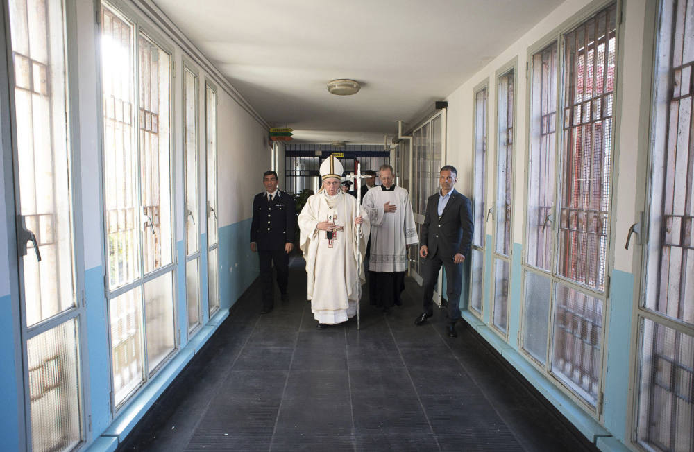 In this April 2, 2015 pool photo Pope Francis, center, holds the pastoral staff as he arrives for a Holy Thursday homily in the Rebibbia prison chapel in Rome. (AP Photo/L'Osservatore Romano, Pool, File)