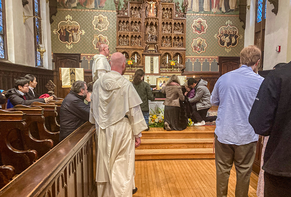 Dominican friars look on while people venerate what is believed to be the skull of St. Thomas Aquinas Nov. 30 in the chapel at the Dominican House of Studies in Washington. (NCR photo/ Carol Zimmermann)