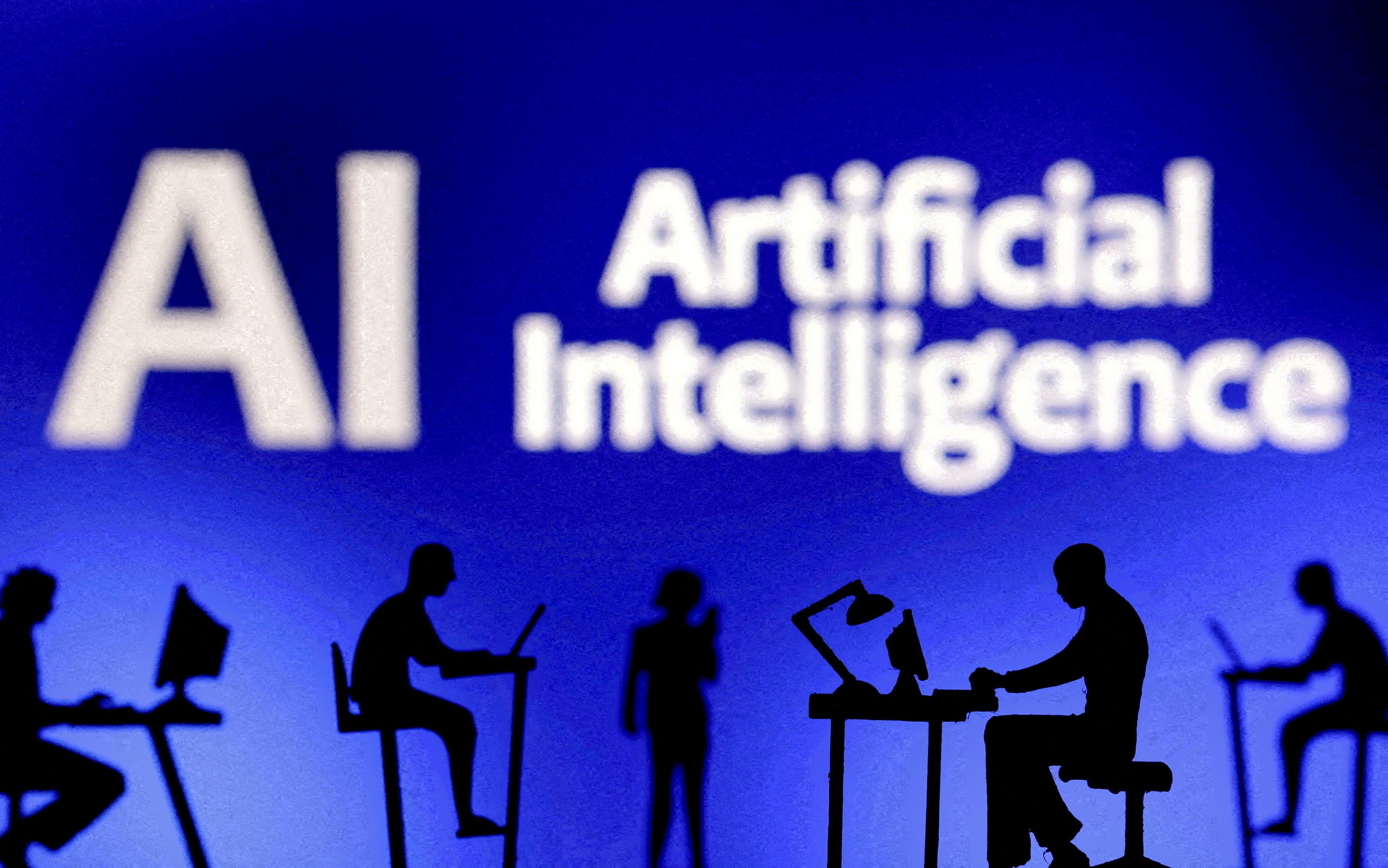 Figurines with computers and smartphones are seen in front of the words "AI Artificial Intelligence" in this Feb. 19, 2024, illustration. (OSV News illustration/Dado Ruvic, Reuters)