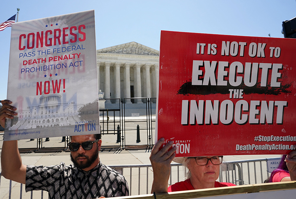 A file photo shows demonstrators holding signs protesting capital punishment in front of the U.S. Supreme Court building in Washington. (OSV News/Reuters/Kevin Lamarque)