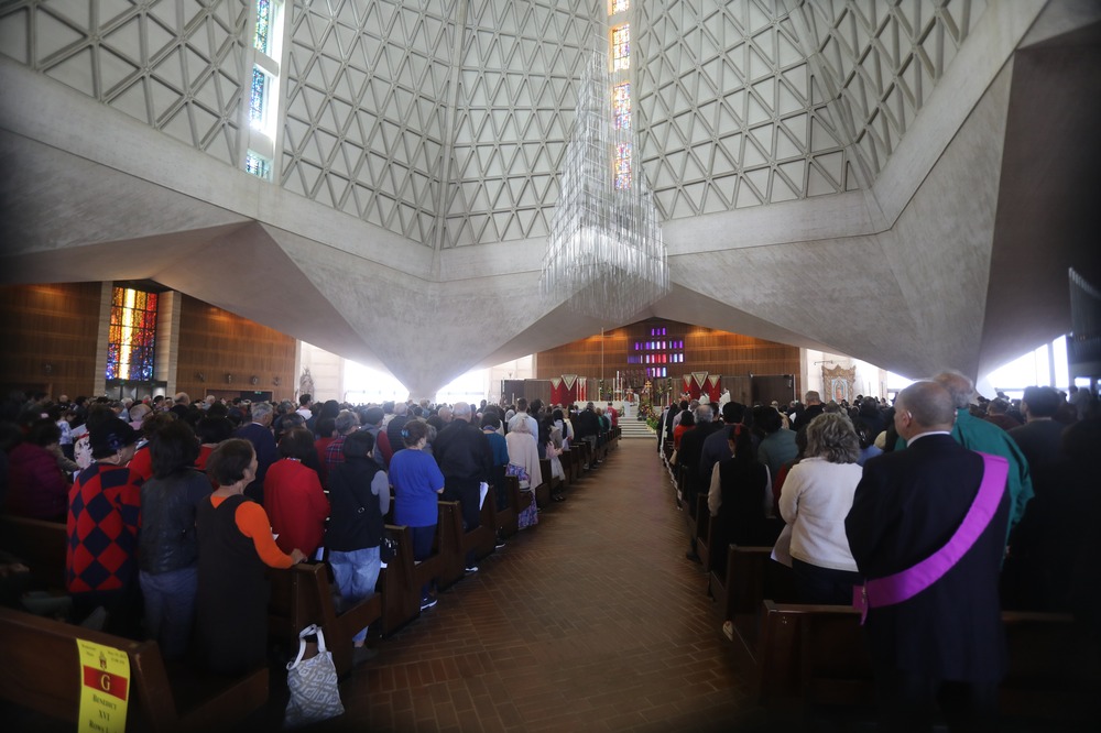 Interior of Cathedral filled with people. 