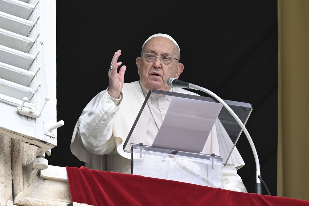 Francis at window, hand raised in blessing.