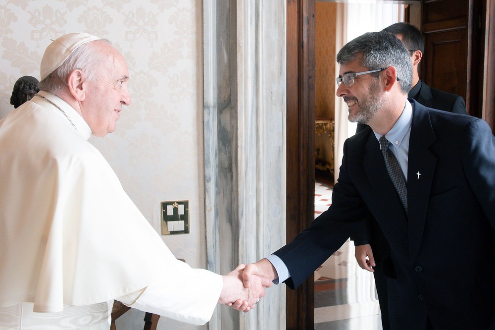 The pope shown shaking Correa's hand.