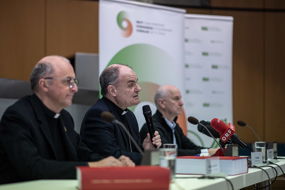 Bishop in middle of panel with other clerics. 