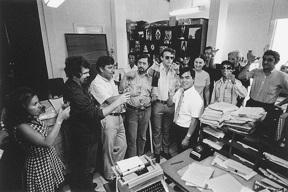 In this undated photo from May 1973, staff in the Associated Press's Saigon bureau celebrate news of Nick Ut's Pulitzer Prize, won for his picture of young Kim Phúc, severely wounded by a napalm strike. Left to right: Edith Lederer, Charles Harrity, Horst Faas, Dang Van Huan (in rear), Richard Pyle, Carl Robinson, Nick Ut, Toby Pyle, Lynn Newland, Dang Van Phuoc, Hugh Mulligan and George Esper. (AP Photo)