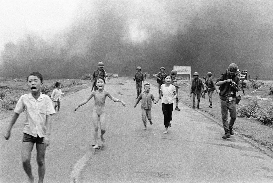 South Vietnamese forces follow after terrified children, including 9-year-old Kim Phúc, center, as they run down Route 1 near Trang Bang after an aerial napalm attack on suspected Viet Cong hiding places, June 8, 1972. A South Vietnamese plane accidentally dropped its flaming napalm on South Vietnamese troops and civilians. The terrified girl had ripped off her burning clothes while fleeing.