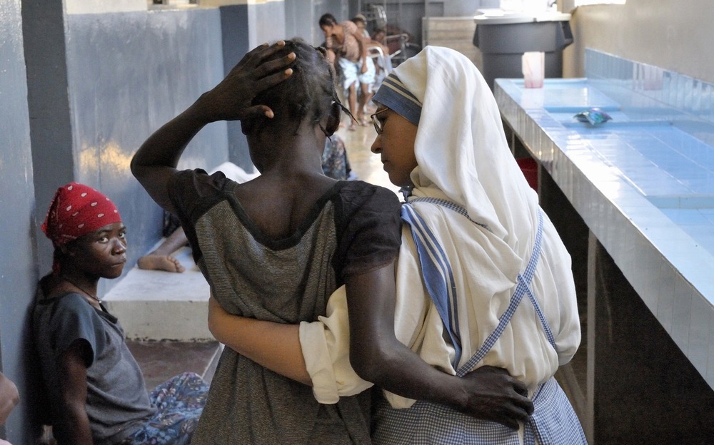 Sister and woman shown from behind walking arm in arm.