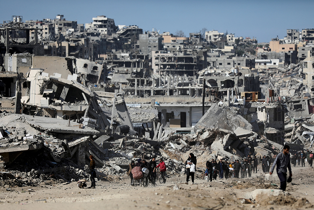 Palestinians make their way past the rubble of destroyed houses and buildings in Jabalia in the northern Gaza Strip, Jan. 21, 2025, following a ceasefire between Israel and Hamas reached Jan. 17. (OSV News/Reuters/Dawoud Abu Alkas)