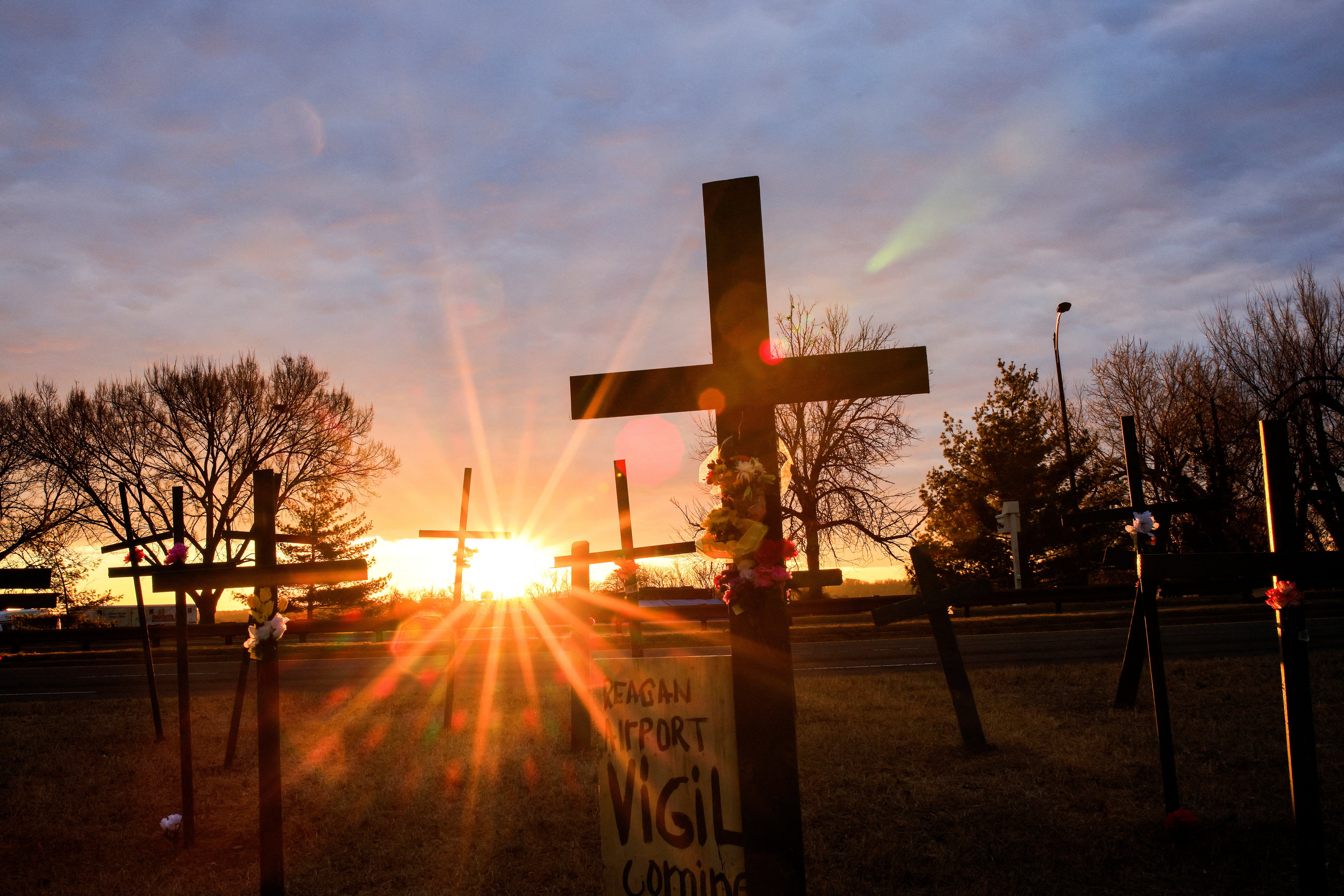 Crosses seen silhouetted in front of setting sun.