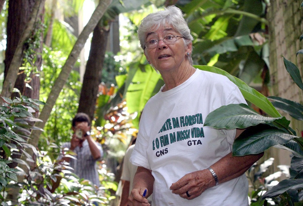 Stang wearing t-shirt and standing in forested area.