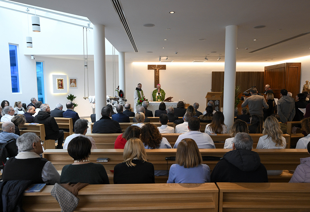 Bishop Claudio Giuliodori, the ecclesiastical assistant to the Catholic University of the Sacred Heart, which includes Rome's Gemelli hospital, celebrates Mass and leads prayers for Pope Francis in the hospital chapel Feb. 24. (CNS/Vatican Media)