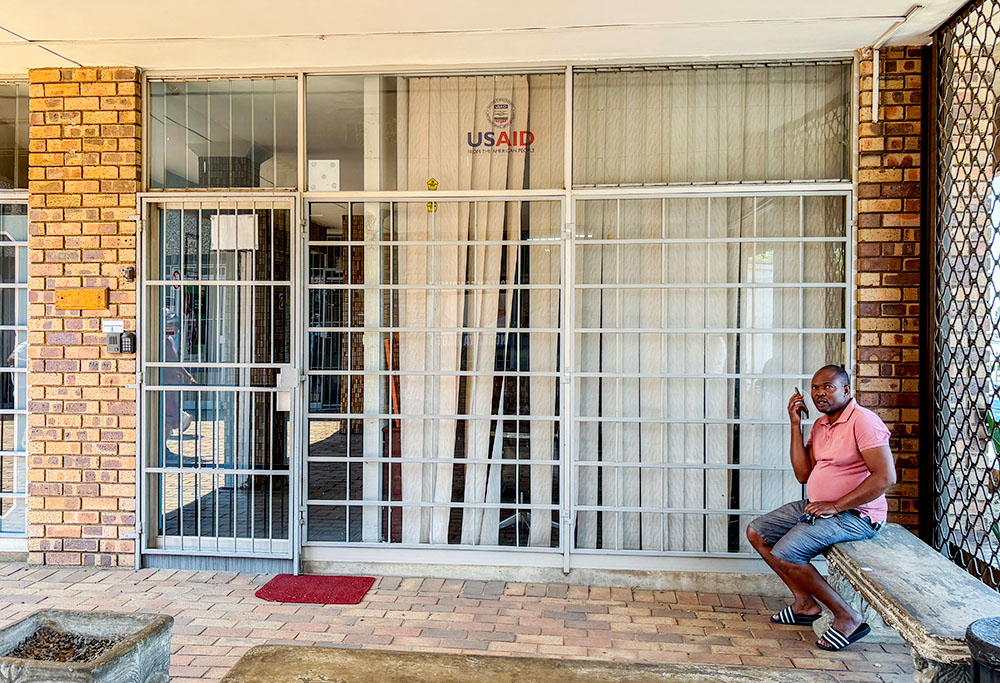 A man sits outside the closed Isizinda Sempilo clinic in the Johannesburg township of Soweto, South Africa, Jan. 30, 2025. (AP/Alfonso Nqunjana)