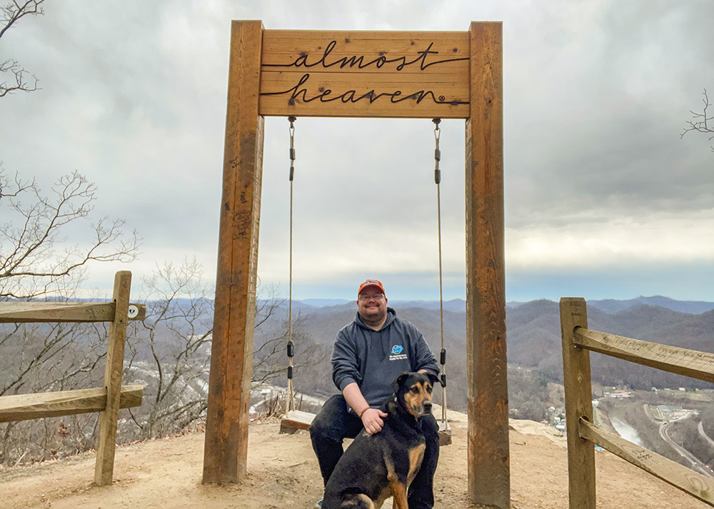 Br. Christian Matson hikes with his dog, Brother Odilo ("Odie"), in West Virginia. (Courtesy of Christian Matson)