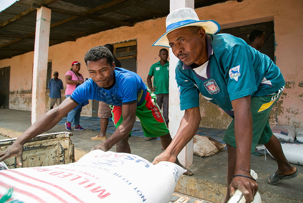 Workers unload food commodities from Catholic Relief Services and USAID in the village of Behera, near Tulear, Madagascar, Oct. 22, 2016. (CNS/Catholic Relief Services/Nancy McNally)