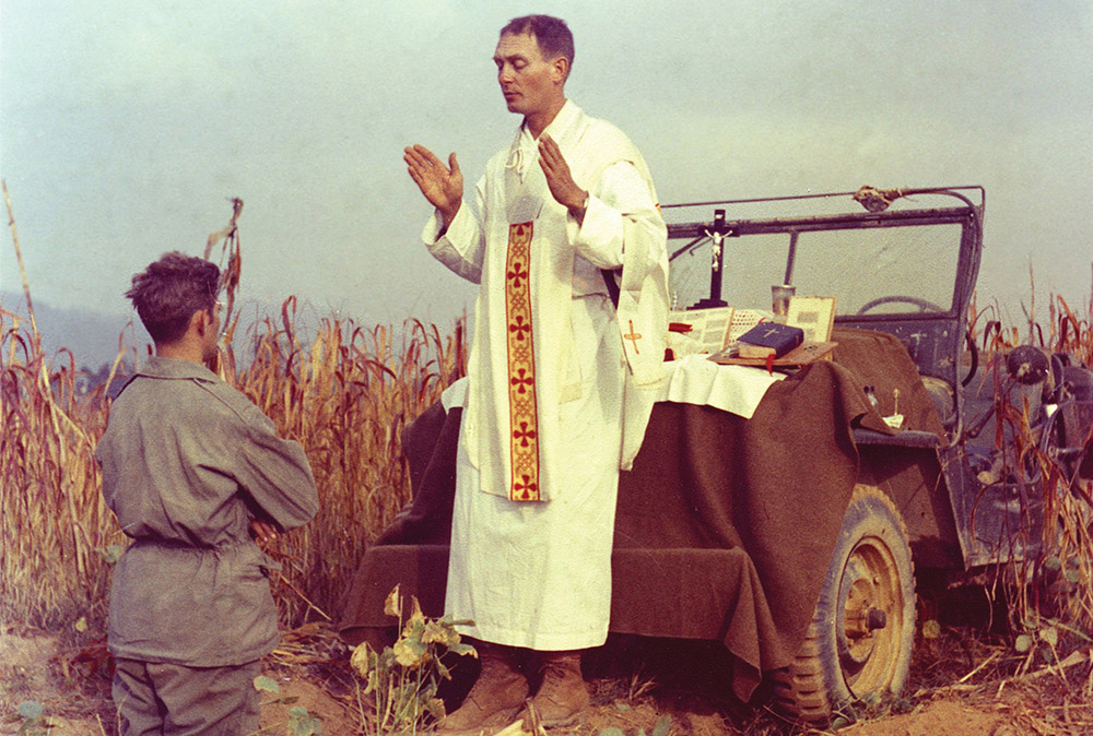 U.S. Army chaplain Fr. Emil Joseph Kapaun, who died May 23, 1951, in a North Korean prisoner of war camp, is pictured celebrating Mass from the hood of a jeep Oct. 7, 1950, in South Korea. He was captured about a month later. (CNS/Courtesy of U.S. Army medic Raymond Skeehan) 