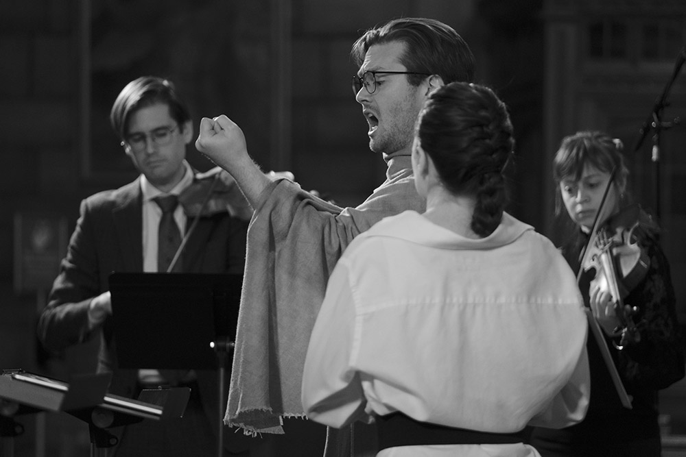 Andrew Leslie Cooper as Clizio (countertenor), with Christina Kay as St. Nicholas (soprano) in foreground perform in "St. Nicholas" on Dec. 17, 2022, at St. Vincent Ferrer Church in New York City. (Courtesy of David Thompson Fairchild)