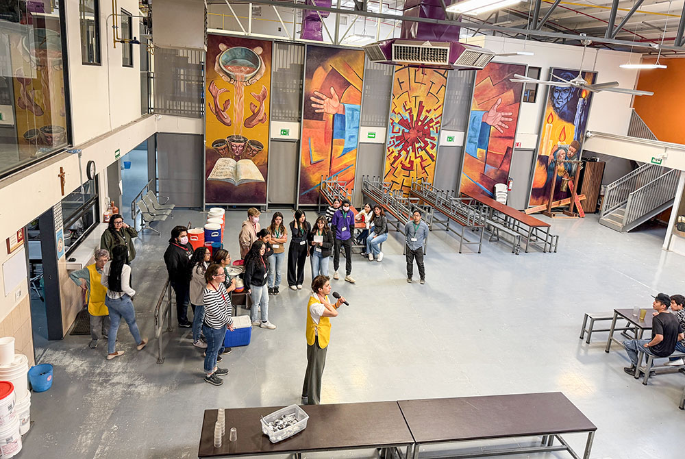 Visiting students from Sacred Heart Preparatory in Atherton, California, get an orientation on Feb. 19, 2025, before they serve breakfast to migrants at the Kino Border Initiative in Nogales, Mexico. (Anita Snow)