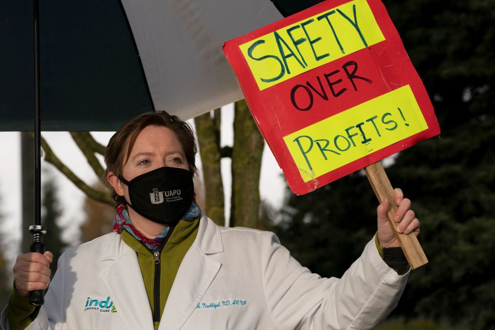 A nurse practitioner pickets outside MultiCare Indigo Urgent Care Puyallup in Puyallup, Wash., Nov. 23, 2020. (CNS/Reuters/David Ryder)