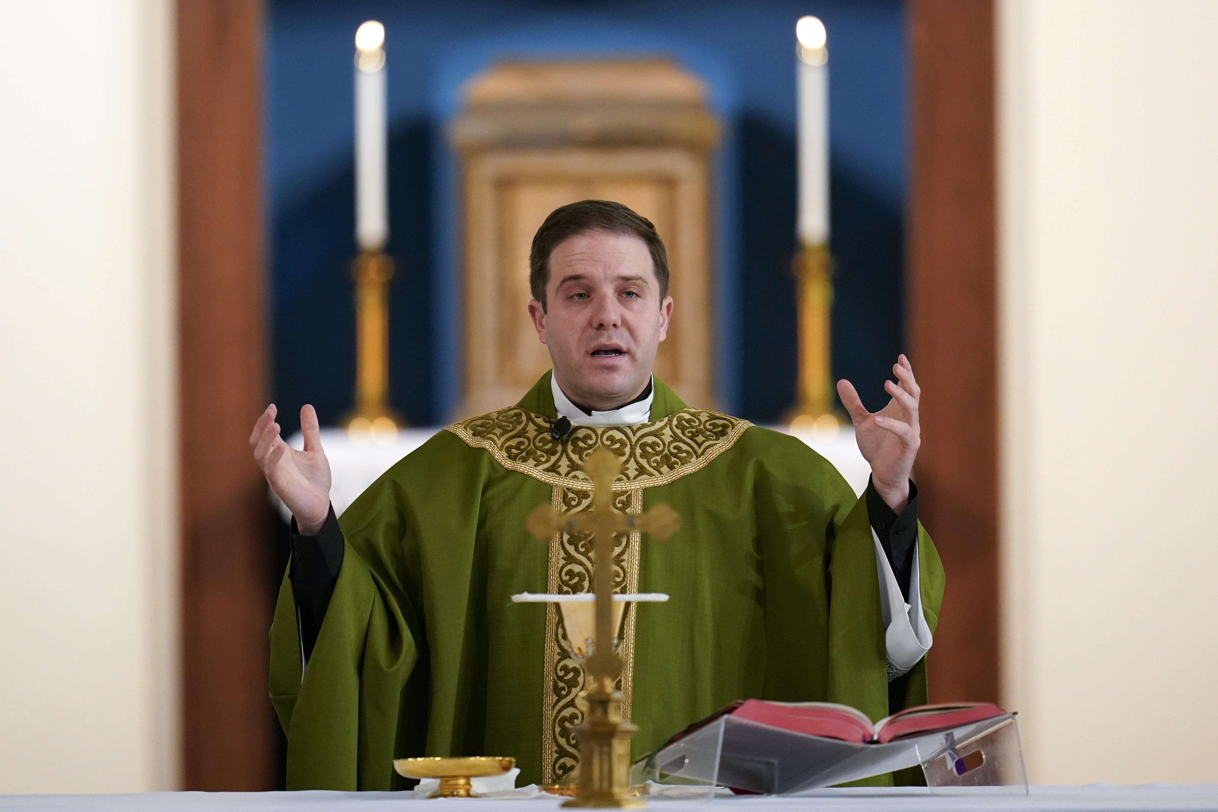 Father Matthew Hood celebrates mass at Our Lady of the Rosary church Friday, Feb. 18, 2022, in Detroit. (AP Photo/Paul Sancya)