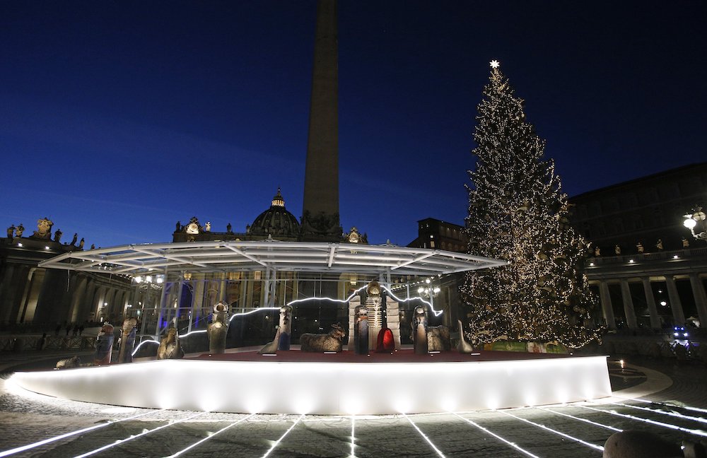 The Vatican's Nativity scene for 2020 is drawing strong reactions. It is set up with the Christmas tree in St. Peter's Square at the Vatican, seen Dec. 14. (CNS/Paul Haring)