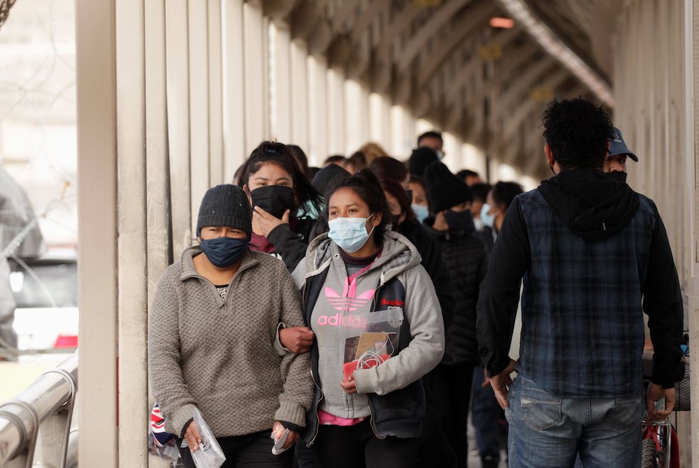 People who were deported from the U.S. walk across Paso del Norte International Border bridge in Ciudad Juarez, Mexico, Feb. 25, 2021. (CNS/Reuters/Jose Luis Gonzalez)