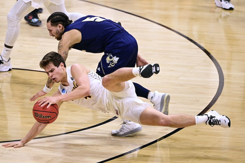 Loyola Ramblers guard Braden Norris dives for the ball against Georgia Tech Yellow Jackets forward Moses Wright March 19, 2021