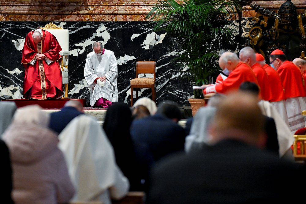 Pope Francis, left, prays as he leads the Good Friday Liturgy of the Lord's Passion April 2, 2020, at the Altar of the Chair in St. Peter's Basilica at the Vatican. (CNS/Reuters pool/Andreas Solaro)