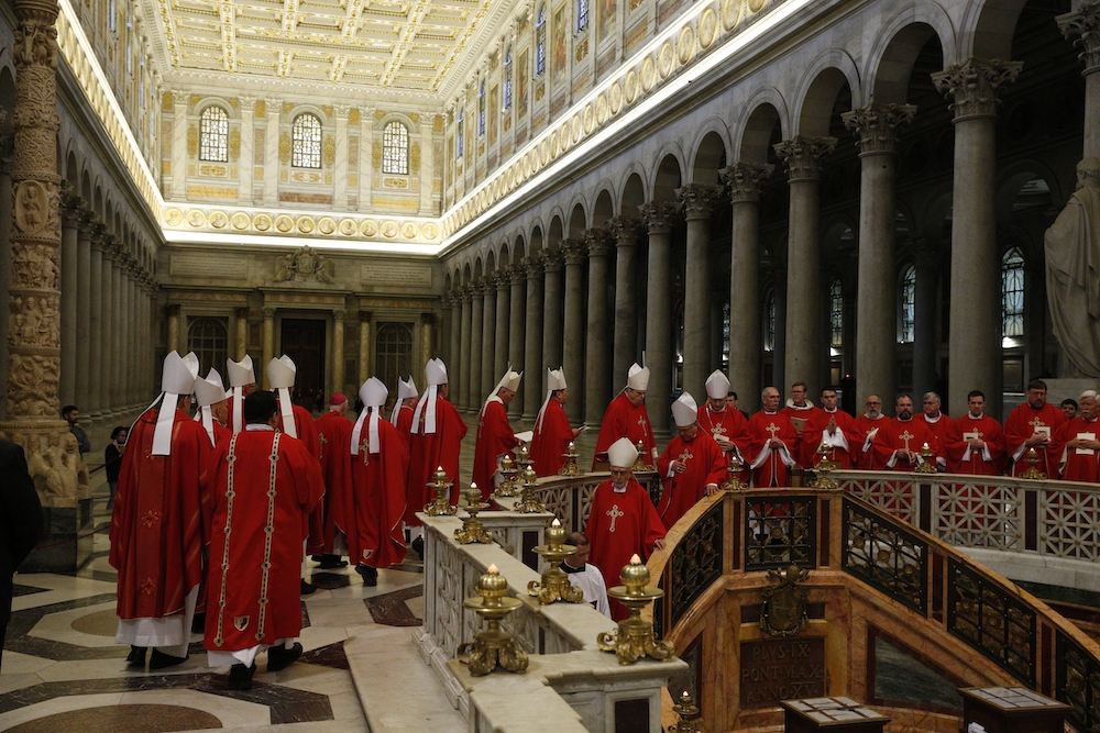 U.S. bishops from Region 13 walk in procession to pray at the tomb of St. Paul after concelebrating Mass at the Basilica of St. Paul Outside the Walls in Rome Feb. 12, 2020, during their "ad limina" visits to the Vatican to report on the status of their d