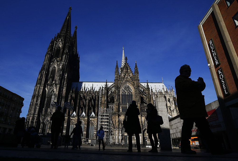 People are silhouetted against the Cologne Cathedral in Germany in 2016. (CNS/Reuters/Wolfgang Rattay)