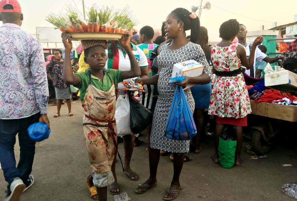 A child hawks carrots at a market in Enugu State, Nigeria. (Patrick Egwu)