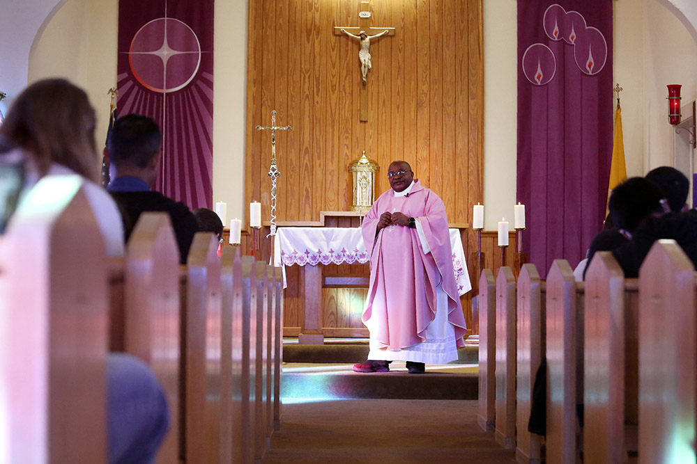 Fr. Athanasius Abanulo celebrates Mass at Holy Family Catholic Church in Lanett, Alabama, on Sunday, Dec. 12, 2021. (AP/Jessie Wardarski)