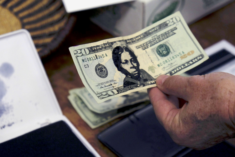 A U.S. $20 bill from the offering plate at Hope Central Church in Boston is stamped with the face of abolitionist Harriet Tubman on June 2. (RNS/Aysha Khan)