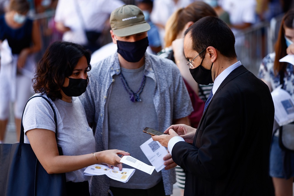 People have their "green pass," signifying vaccination against COVID-19 or a negative test taken within 48 hours, checked before entering the Vatican Museums at the Vatican in this Aug. 6, 2021, file photo.