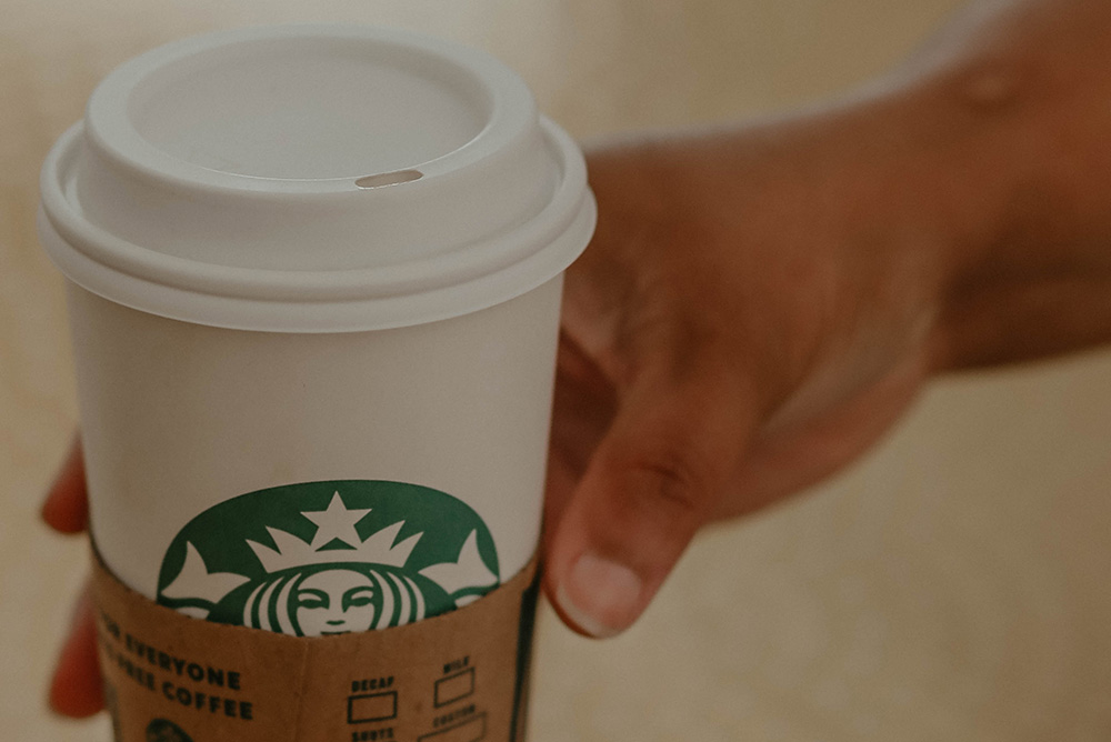 Starbucks coffee cup (Unsplash/Kadarius Seegars)