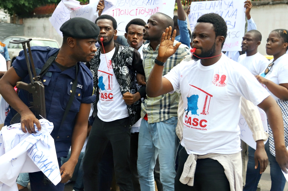 Police officers attempt to disperse members of the Civil Society Action Collective chanting slogans in a demonstration calling for free and fair elections Sept. 19 in Kinshasa, Democratic Republic of Congo. (Newscom/Reuters/Kenny Katombe)