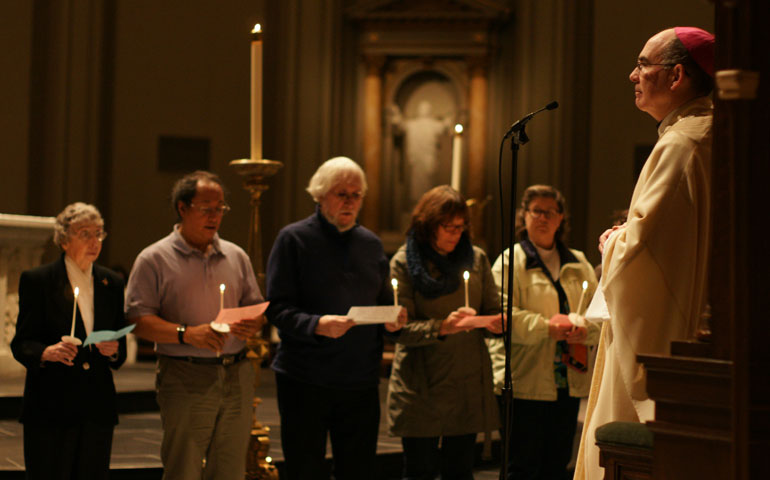 Members of Pax Christi take a Vow of Nonviolence, received by Seattle Archbishop Peter Sartain, right. (Photo courtesy of Maria Laughlin)